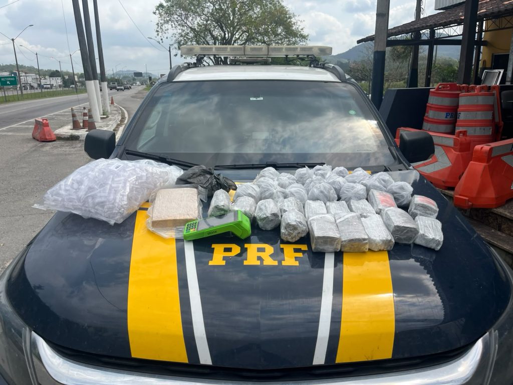 Motorista foi detido após policiais encontrarem centenas de invólucros e um tablete de maconha e skunk durante fiscalização.